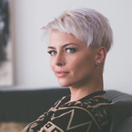 female with dyed hair sitting on a chair